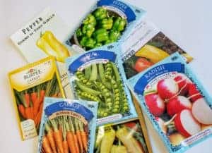 Seed packets for peppers, peas, carrots and radish.